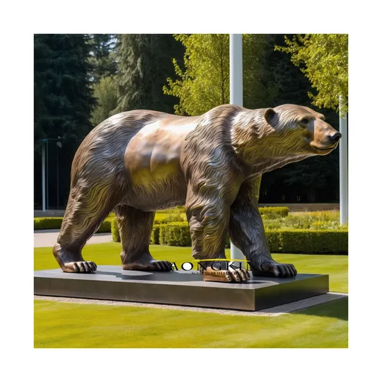 Bronze People with a Bear Statue Standing on The Ground 
